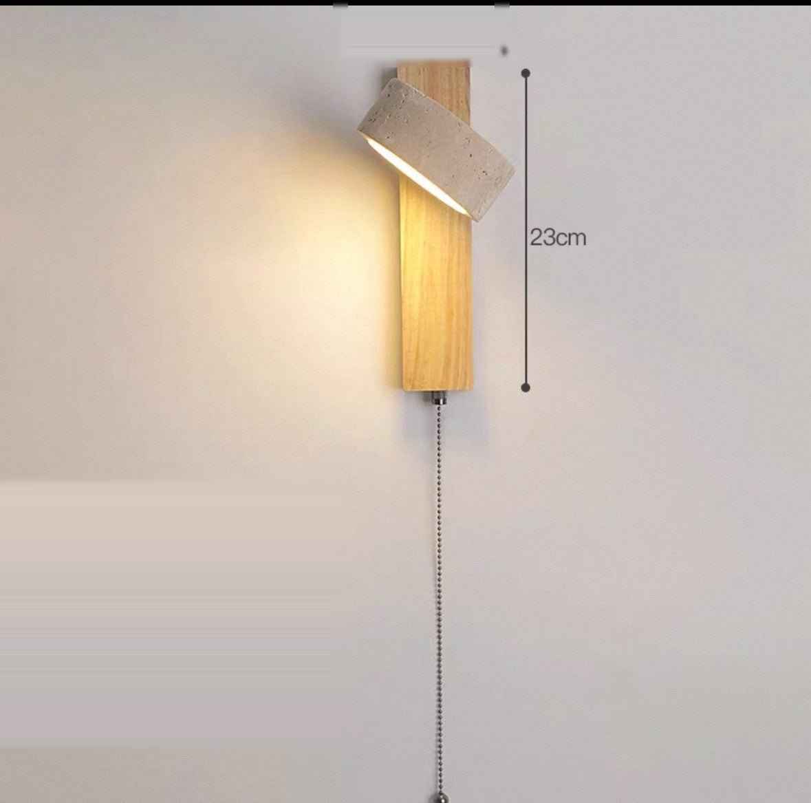 Natural wood wall sconce with a pull-cord switch, shade angled