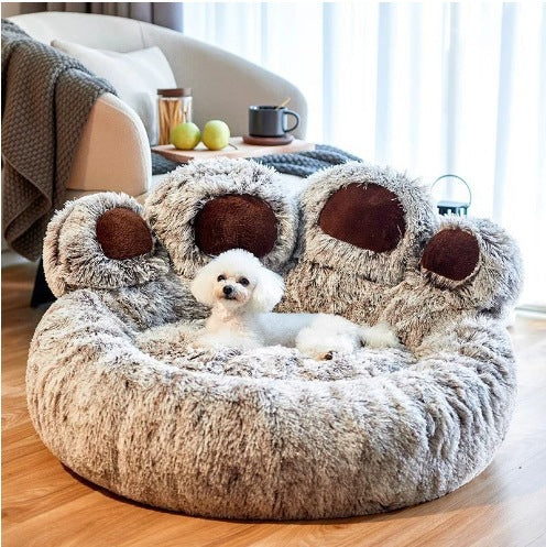 Small dog sitting in the warm coffee plush paw pet bed in a living room