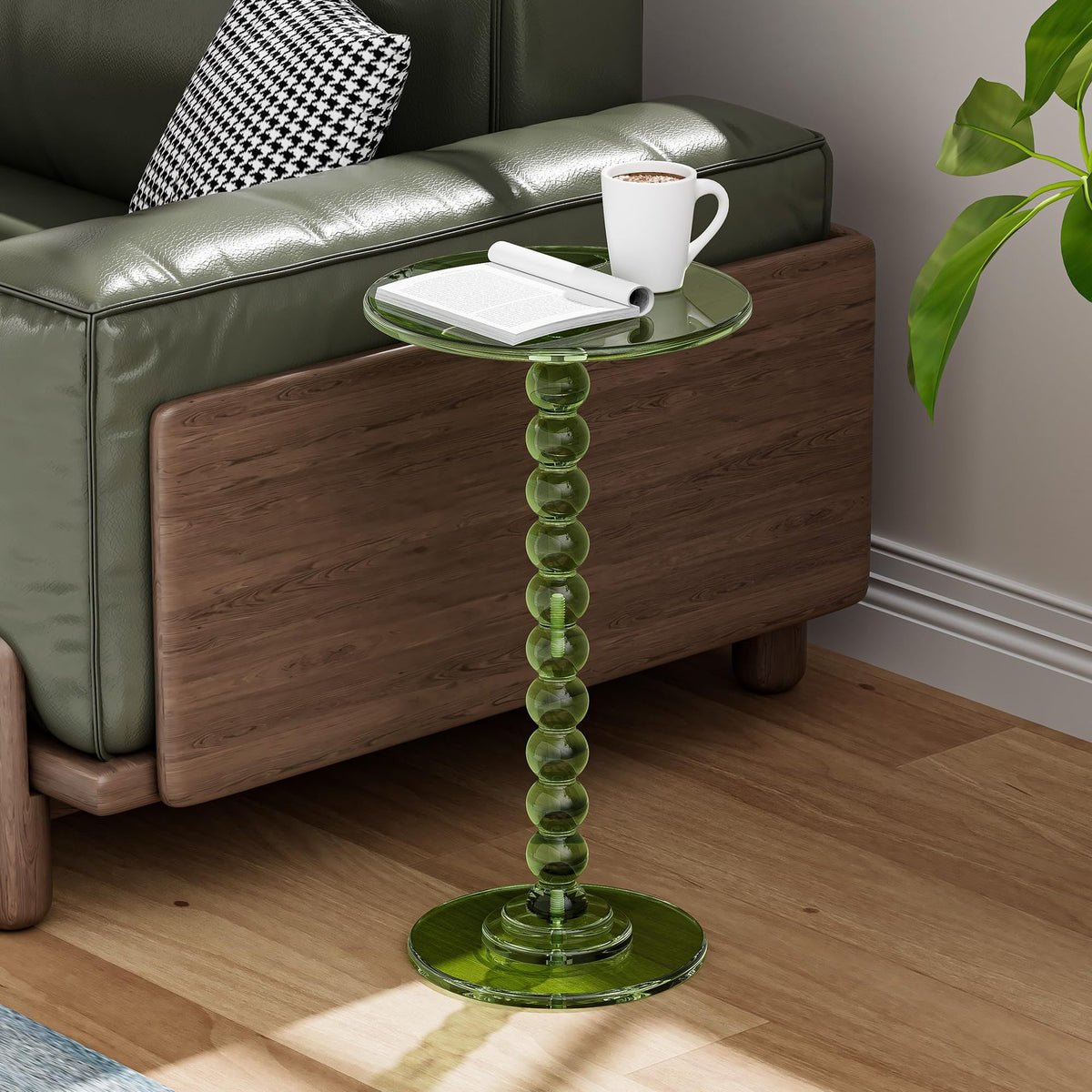 Green acrylic pedestal side table beside a sofa in a living room