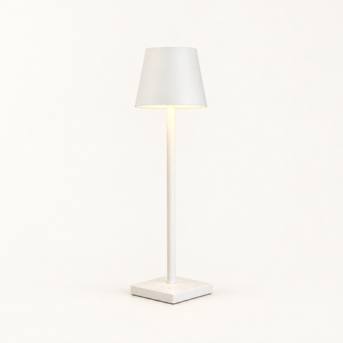 Aluminum cordless table lamp on a plain warm off-white background