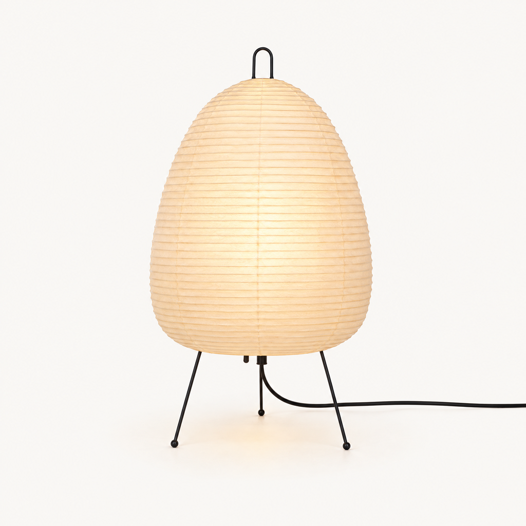 Rice paper lamp lit from within on a plain warm off-white background