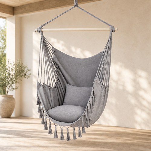 Light grey canvas hanging chair with cushions on a covered porch