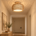 Woven rattan drum ceiling light flush-mounted in a warm entryway